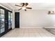 Spacious living room features a ceiling fan, tile flooring, and glass doors leading to a patio area at 5505 Reiter Ave, Las Vegas, NV 89108