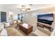 Spacious living room featuring plush carpeting, a large sofa, and a mounted television at 5505 Reiter Ave, Las Vegas, NV 89108