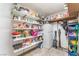 Pantry with white shelves and a white refrigerator, providing ample storage space at 5505 Reiter Ave, Las Vegas, NV 89108