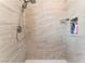 Modern shower featuring elegant tile work, a shower niche, and sleek fixtures at 5505 Reiter Ave, Las Vegas, NV 89108