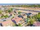 Community aerial view with houses, landscaping, streets, and nearby highway with city skyline in the distance at 5653 Artesia Lake Ct, Las Vegas, NV 89118