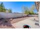 A low-maintenance backyard featuring decorative rock, a brick retaining wall, and a concrete patio at 5653 Artesia Lake Ct, Las Vegas, NV 89118