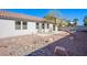 A low-maintenance backyard featuring decorative rock, a brick retaining wall, and a concrete patio at 5653 Artesia Lake Ct, Las Vegas, NV 89118