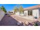 Low maintenance backyard with rock, block wall, patio and uniquely shaped shade tree at 5653 Artesia Lake Ct, Las Vegas, NV 89118