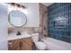 Stylish bathroom featuring a vanity with herringbone accents, modern fixtures, and a tiled shower-tub combo at 5653 Artesia Lake Ct, Las Vegas, NV 89118