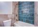 Modern bathroom with teal tiled shower and niche plus separate soaking tub at 5653 Artesia Lake Ct, Las Vegas, NV 89118