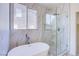 Bathroom featuring a soaking tub and separate glass-enclosed shower at 5653 Artesia Lake Ct, Las Vegas, NV 89118