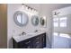 Bathroom vanity with dual sinks and decorative framed mirrors above at 5653 Artesia Lake Ct, Las Vegas, NV 89118