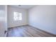 Bedroom with wood-look floors and a window for natural light at 5653 Artesia Lake Ct, Las Vegas, NV 89118