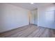 Spacious bedroom with wood-look floors and closet with sliding doors at 5653 Artesia Lake Ct, Las Vegas, NV 89118