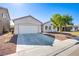 Charming single-story home with a well-maintained yard, two-car garage, and desert landscaping at 5653 Artesia Lake Ct, Las Vegas, NV 89118