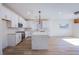 Bright, open kitchen with stainless steel appliances, white cabinets, and a large marble island at 5653 Artesia Lake Ct, Las Vegas, NV 89118