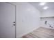A utilitarian laundry room with vinyl floors at 5653 Artesia Lake Ct, Las Vegas, NV 89118