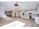 Open floor plan with kitchen island, living room, and modern fireplace at 5653 Artesia Lake Ct, Las Vegas, NV 89118