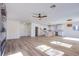 Open concept living room and kitchen featuring an eye-catching fireplace and wood flooring at 5653 Artesia Lake Ct, Las Vegas, NV 89118