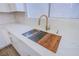 Close up on the sink with quartz countertops and a cutting board in the sink at 5653 Artesia Lake Ct, Las Vegas, NV 89118