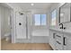 Bright bathroom featuring a separate shower, soaking tub, and vanity at 715 Taliput Palm Pl, Henderson, NV 89011