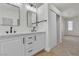 Bright bathroom featuring a walk-in closet, double sinks, and vanity at 715 Taliput Palm Pl, Henderson, NV 89011