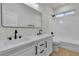 Well-lit bathroom features a double sink vanity, sleek fixtures, and a tub with shower at 715 Taliput Palm Pl, Henderson, NV 89011