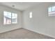 Bright bedroom features two windows and neutral walls creating a serene atmosphere at 715 Taliput Palm Pl, Henderson, NV 89011