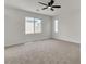 Bright bedroom featuring neutral carpet, ceiling fan, and lots of natural light from the windows at 715 Taliput Palm Pl, Henderson, NV 89011