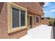 View of the home's exterior showing the back entrance and small patio area at 715 Taliput Palm Pl, Henderson, NV 89011