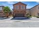 Charming townhome features stucco siding, a well-maintained yard, and a two-car garage at 715 Taliput Palm Pl, Henderson, NV 89011