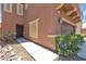Townhome with stucco exterior, tidy desert landscaping and an attached two-car garage at 715 Taliput Palm Pl, Henderson, NV 89011