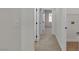 Bright hallway features neutral carpet and fresh white walls with modern door hardware at 715 Taliput Palm Pl, Henderson, NV 89011