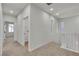 Bright hallway features neutral carpet and fresh white walls and staircase with natural light at 715 Taliput Palm Pl, Henderson, NV 89011