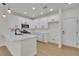 Modern kitchen with white cabinets, quartz countertops, stainless steel appliances at 715 Taliput Palm Pl, Henderson, NV 89011