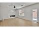 Bright living room features wood floors, modern fireplace and a ceiling fan at 715 Taliput Palm Pl, Henderson, NV 89011