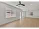 Bright, airy living room with hardwood flooring, modern lighting and a glass patio door at 715 Taliput Palm Pl, Henderson, NV 89011