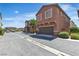 View of a row of townhomes with desert landscaping and attached garages at 715 Taliput Palm Pl, Henderson, NV 89011