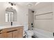 Contemporary bathroom with sleek vanity, modern fixtures, and shower-tub combo at 7221 W Washington Ave, Las Vegas, NV 89128