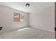 Cozy carpeted bedroom with a window view of the neighborhood, offering a serene retreat at 7221 W Washington Ave, Las Vegas, NV 89128