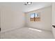 Bedroom with carpet, neutral walls, and a view of backyard, ideal for relaxation and privacy at 7221 W Washington Ave, Las Vegas, NV 89128