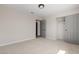 Comfortable bedroom featuring neutral walls, plush carpeting, closet, and doorway to another room at 7221 W Washington Ave, Las Vegas, NV 89128