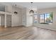 Bright and airy living area with large windows, hardwood floors, and modern light fixtures at 7221 W Washington Ave, Las Vegas, NV 89128