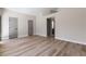 Bright, expansive living room with wood flooring and neutral walls, showcasing a view into the entry and hallway at 7221 W Washington Ave, Las Vegas, NV 89128