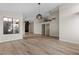 Open-concept living area with wood-style flooring, fireplace, and modern light fixtures at 7221 W Washington Ave, Las Vegas, NV 89128