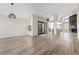 Bright living room featuring wood-style floors and modern lighting fixtures at 7221 W Washington Ave, Las Vegas, NV 89128