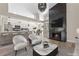 Open-concept living space with a fireplace, a breakfast bar, and a view to the dining room at 7221 W Washington Ave, Las Vegas, NV 89128