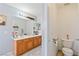 Bathroom featuring double sinks, wood cabinets, and a separate toilet room at 728 Twilight Blue Ave, North Las Vegas, NV 89032