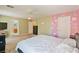 Bright bedroom with a unique accent wall, ceiling fan, and ample closet space at 728 Twilight Blue Ave, North Las Vegas, NV 89032