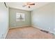 Bedroom features plush carpeting, a ceiling fan, and ample natural light from a window at 728 Twilight Blue Ave, North Las Vegas, NV 89032