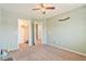 Light green bedroom featuring ceiling fan, closet, carpet and access to other areas at 728 Twilight Blue Ave, North Las Vegas, NV 89032