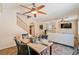 Open-concept dining area with ceiling fan, view to living room, and tile floors at 728 Twilight Blue Ave, North Las Vegas, NV 89032