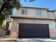 Two-story townhouse with a two-car garage and a red tile roof, offering comfortable suburban living at 728 Twilight Blue Ave, North Las Vegas, NV 89032