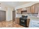 Kitchen featuring granite countertops, stainless steel range, and dark cabinetry with ample space at 728 Twilight Blue Ave, North Las Vegas, NV 89032